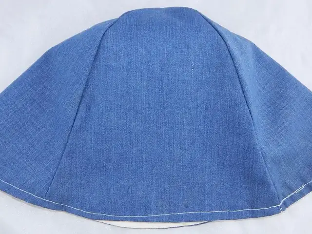 A mid-blue denim bucket hat laid flat, crown up, on a white background.